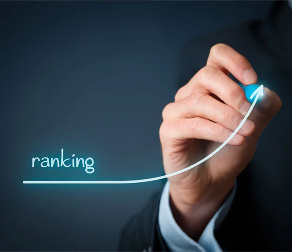 A hand drawing a rising ranking curve on a dark screen