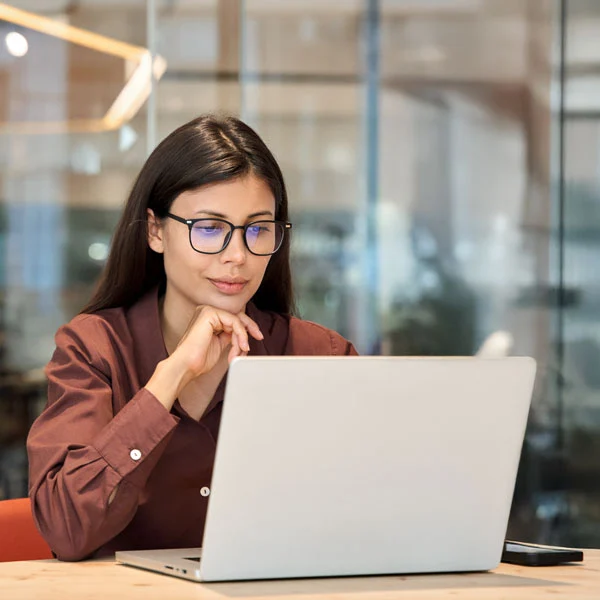 A tech professional reviewing search performance on a laptop